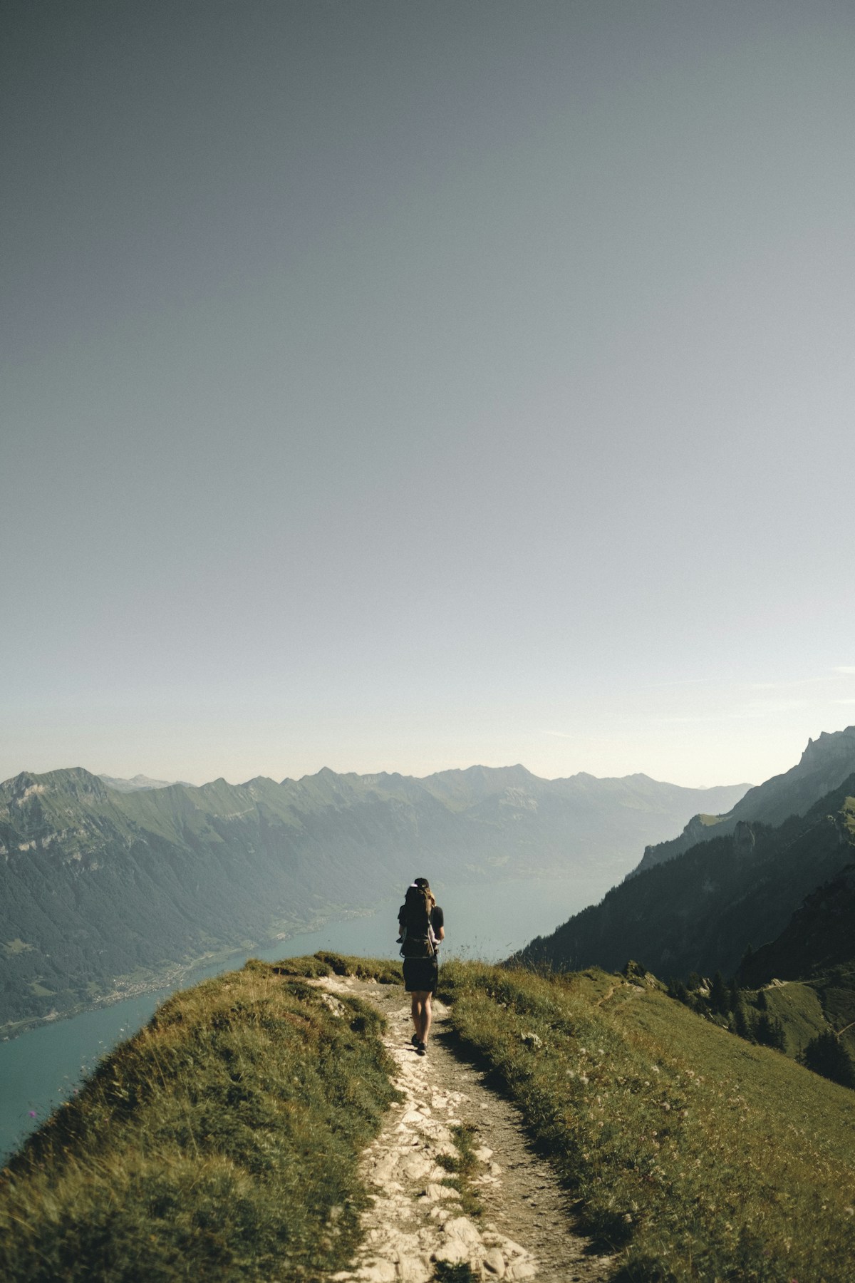 Hikers walking along a mountain trail with backpacks