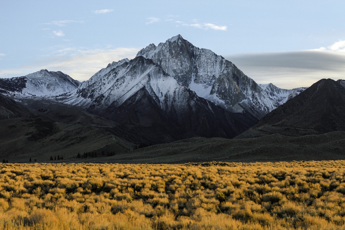 Sunrise over mountain peaks with golden light illuminating the landscape