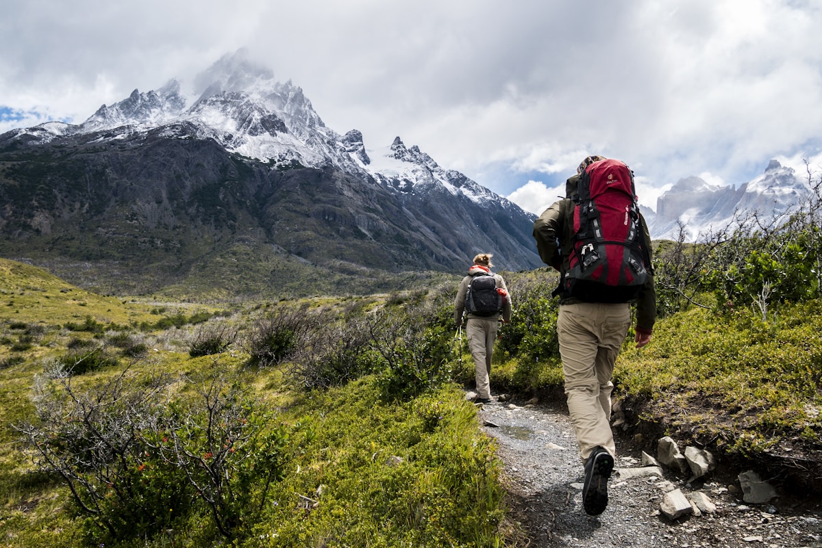 Hikers trekking through mountain terrain on a multi-day expedition